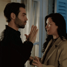 a man and a woman are looking at each other