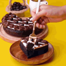 a person is holding a fork over a piece of cake