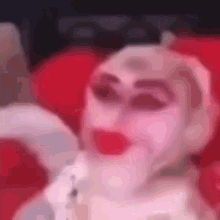 a close up of a puppet with a face painted like a woman .