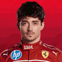a man is wearing a red shirt with ibm and hp logos on it