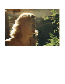a picture of a woman 's face with a fence in the background