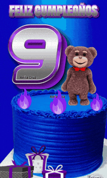 a blue cake with a teddy bear and a number 9 on top