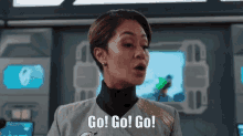 a woman says go go go in front of a screen
