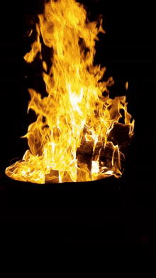 a large fire burning in the dark with a lot of flames