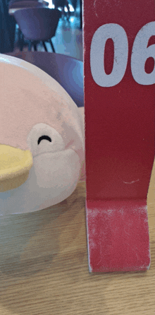 a stuffed animal is sitting next to a red sign that says 00