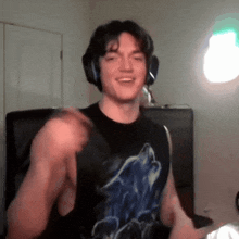 a young man wearing headphones and a tank top with a wolf on it