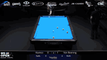 a pool table with a blue cloth and a diamond logo on it
