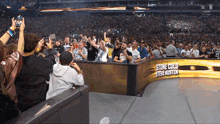 a crowd of people in a stadium with a sign that says " stone cold steve austin "