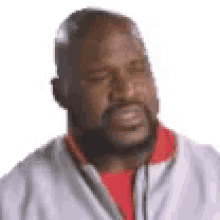 a man with a beard is making a funny face with his eyes closed and his mouth open .