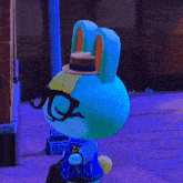 a blue bunny with glasses and a k on his shirt