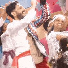 a group of people are dancing in front of a sign that says sony music on it