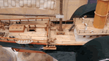 a model of a ship has a sign on the side that says ' t.l.c. '