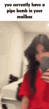 a woman in a red shirt is taking a selfie with a caption that says you currently have a pipe bomb in your mail