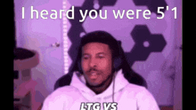 a man wearing headphones says i heard you were 5 ' 1 .