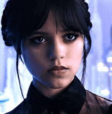 a close up of a woman 's face with dark hair