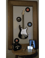 a jack daniels box sits on a table next to an electric guitar
