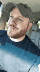 a man with a beard wearing a hat that says ' a.j. ' on it
