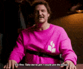 a man wearing a pink sweatshirt says it 's fine take me to jail i could use the break