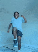 a man wearing headphones and a t-shirt that says ice is jumping in the air