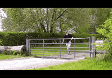 a man is walking through a gate that has a sign on it that says victoria