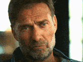 a close up of a man 's face with a beard and a caption that says " guilty "