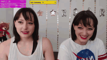 two girls are smiling in front of a sign that says sub giveaway