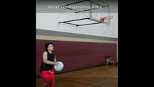 a man playing basketball in a gym with the words round winning kill above him