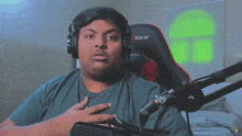 a man wearing headphones is sitting in a cer chair
