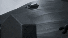 a lego figure is standing in front of a rock