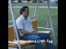 a man sits on a swing with the words spieler ohne lhp-tag written below him