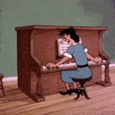 a woman in a blue dress is playing a piano in a room