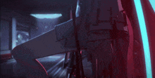 a close up of a person 's arm with a red light behind them