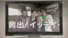 a tv screen shows three people giving peace signs and says super-gif-taiben on the bottom