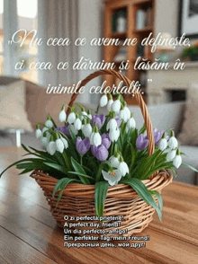 a wicker basket filled with snowdrop flowers sits on a wooden table