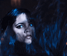 a close up of a woman with blue eyes