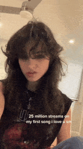 a girl with long hair is wearing a black tank top that says 25 million streams on my first song i love u sm