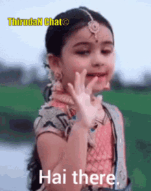 a little girl is making a funny face and says hai there