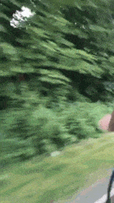 a blurred image of a person riding a bike down a road