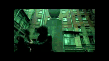 a man is playing a guitar on the edge of a building
