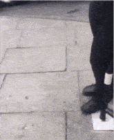 a person standing on a sidewalk with a sticker on their ankle