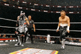 two wrestlers are in a ring with the word raw on the wall behind them