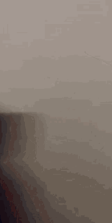 a blurry picture of a man 's face with his finger pointing at the camera