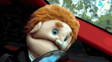 a puppet is sitting in the driver 's seat in a car