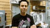a man wearing a t-shirt that says ' i love you ' on it is standing in a room .