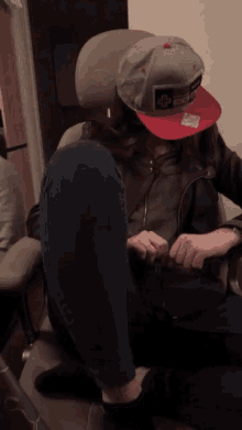 a girl wearing a hat with a picture of a man on it