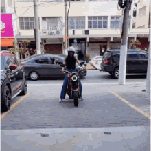 a woman is riding a motorcycle in a parking lot in front of a building that says ' ioto ' on it