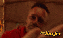 a blurred image of a person with the words the surfer on the bottom right