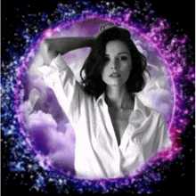 a woman in a white shirt is surrounded by purple smoke