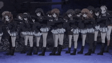 a group of anime girls are standing next to each other with their arms in the air .