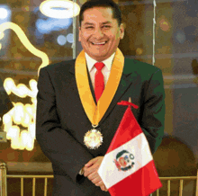 a man in a suit and tie holding a small flag